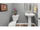 Compact bathroom features a pedestal sink, toilet, and decorative accents at 78 N Porcenna Ln, Clayton, NC 27527