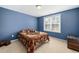 Comfortable bedroom with blue walls, natural lighting, and ample space for rest and relaxation at 78 N Porcenna Ln, Clayton, NC 27527
