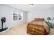 Light and airy bedroom with a neutral palette, large window, and comfortable furnishings at 78 N Porcenna Ln, Clayton, NC 27527