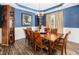Elegant dining room featuring stylish furnishings, hardwood floors, and a sophisticated chandelier at 78 N Porcenna Ln, Clayton, NC 27527