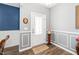 Stylish entryway featuring elegant wainscoting, decor accents, and hardwood flooring at 78 N Porcenna Ln, Clayton, NC 27527