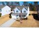 Aerial view of a two-story home boasts a two-car garage and manicured front lawn at 78 N Porcenna Ln, Clayton, NC 27527