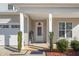 Welcoming front porch featuring a covered entrance and manicured landscaping at 78 N Porcenna Ln, Clayton, NC 27527