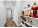 Hallway featuring hardwood floors and decorative shelving at 78 N Porcenna Ln, Clayton, NC 27527