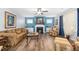 Spacious living room with hardwood floors, a fireplace, and comfortable seating at 78 N Porcenna Ln, Clayton, NC 27527