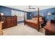 Spacious main bedroom with a four-poster bed, dark wood furniture and natural light from a large window at 78 N Porcenna Ln, Clayton, NC 27527
