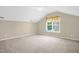 Bright bedroom featuring a window with curtains, neutral walls and plush carpeting at 7807 Braefield Dr, Raleigh, NC 27616
