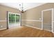 The dining room has a chandelier and sliding glass door overlooking backyard at 7807 Braefield Dr, Raleigh, NC 27616