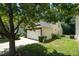 View of the home's tan siding, well-manicured lawn, and stone accents on the attached garage at 7807 Braefield Dr, Raleigh, NC 27616