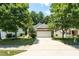 Charming single-Gathering home featuring a two-car garage and mature trees surrounding the property at 7807 Braefield Dr, Raleigh, NC 27616