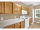 The well-lit kitchen includes plenty of counter space and a white range and microwave at 7807 Braefield Dr, Raleigh, NC 27616
