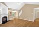 Bright living room featuring vaulted ceiling, fireplace and wood laminate flooring at 7807 Braefield Dr, Raleigh, NC 27616