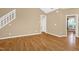 Second view of the bright living room featuring vaulted ceiling and wood laminate flooring at 7807 Braefield Dr, Raleigh, NC 27616