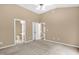 Carpeted bedroom boasts a ceiling fan, walk-in closet, and ensuite bathroom at 7807 Braefield Dr, Raleigh, NC 27616