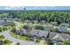 Aerial view of a well-maintained neighborhood with mature trees, sidewalks, and meticulously landscaped yards at 8007 Crookneck Dr, Angier, NC 27501