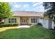 The backyard is landscaped with green grass and a storage building. The patio area is perfect for outdoor living at 8007 Crookneck Dr, Angier, NC 27501