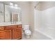 Neutral bathroom featuring single vanity, toilet, and tub shower combination at 8007 Crookneck Dr, Angier, NC 27501