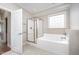 Bathroom showcasing a tub with shower, a window, and natural lighting at 8007 Crookneck Dr, Angier, NC 27501