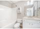 Bathroom featuring a shower-tub combination and single sink vanity with storage at 8007 Crookneck Dr, Angier, NC 27501