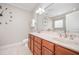 Bathroom featuring a double vanity, large mirror, and neutral color scheme at 8007 Crookneck Dr, Angier, NC 27501