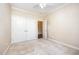 Neutral bedroom showing double-door closet and light carpet flooring at 8007 Crookneck Dr, Angier, NC 27501