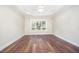 Neutral bedroom featuring hard surface flooring, large window, and ceiling fan at 8007 Crookneck Dr, Angier, NC 27501
