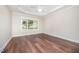 Neutral bedroom featuring light carpet flooring, large window, and ceiling fan at 8007 Crookneck Dr, Angier, NC 27501
