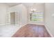 Dining room features hardwood floors, a chandelier, and view to adjacent room through French doors at 8007 Crookneck Dr, Angier, NC 27501