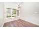 Dining room shows hardwood floors, window to backyard, crown moulding, and chandelier at 8007 Crookneck Dr, Angier, NC 27501