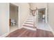 Welcoming entryway featuring wood and tile floors, stairs, and convenient half bath at 8007 Crookneck Dr, Angier, NC 27501