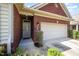 Brick home featuring a two-car garage and welcoming front entrance at 8007 Crookneck Dr, Angier, NC 27501
