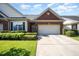 Charming brick home featuring a two-car garage, manicured lawn, and beautiful landscaping at 8007 Crookneck Dr, Angier, NC 27501