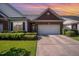 Charming brick home featuring a two-car garage, manicured lawn, and beautiful landscaping at 8007 Crookneck Dr, Angier, NC 27501
