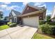 Charming brick home featuring a two-car garage, manicured lawn, and beautiful landscaping at 8007 Crookneck Dr, Angier, NC 27501