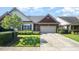 Charming brick home featuring a two-car garage, manicured lawn, and beautiful landscaping at 8007 Crookneck Dr, Angier, NC 27501