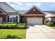 Charming brick home featuring a two-car garage, manicured lawn, and beautiful landscaping at 8007 Crookneck Dr, Angier, NC 27501