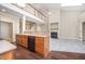 Kitchen features stainless steel appliances, hardwood floors and an open view to the living room at 8007 Crookneck Dr, Angier, NC 27501