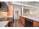 Kitchen features stainless steel appliances, hardwood floors and an open view to the staircase at 8007 Crookneck Dr, Angier, NC 27501