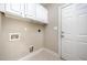 Laundry room with white cabinets and tile floors, offering practicality and functionality at 8007 Crookneck Dr, Angier, NC 27501