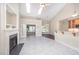Bright living room with fireplace, French doors to another room, and bar seating to kitchen at 8007 Crookneck Dr, Angier, NC 27501