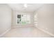 Neutral room featuring tile flooring, large window and door, and ceiling fan at 8007 Crookneck Dr, Angier, NC 27501