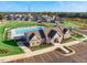 Aerial view featuring a pool, clubhouse, and manicured landscaping, creating an inviting community space at 817 James J Freeland Memorial Dr, Hillsborough, NC 27278
