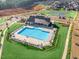 Aerial view shows the community pool, clubhouse, and tennis courts for active outdoor enjoyment at 817 James J Freeland Memorial Dr, Hillsborough, NC 27278