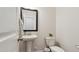 Modern half-bathroom with pedestal sink, mirror, and updated fixtures at 817 James J Freeland Memorial Dr, Hillsborough, NC 27278