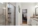 Modern bathroom with a glass-enclosed shower, neutral tile, and walk-in closet access at 817 James J Freeland Memorial Dr, Hillsborough, NC 27278