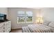 Comfortable bedroom with lots of natural light and a gray upholstered ottoman at the foot of the bed at 817 James J Freeland Memorial Dr, Hillsborough, NC 27278