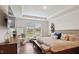 Bright bedroom featuring tray ceiling, modern furnishings, and a window seat overlooking the front yard at 817 James J Freeland Memorial Dr, Hillsborough, NC 27278