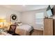 Cozy bedroom featuring a decorative wreath above the headboard and lots of natural light at 817 James J Freeland Memorial Dr, Hillsborough, NC 27278