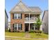 Charming two-story home with a stone facade, covered porch, and well-manicured lawn at 817 James J Freeland Memorial Dr, Hillsborough, NC 27278