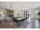 Spacious living room with a stone fireplace, elegant chandeliers, and large windows at 817 James J Freeland Memorial Dr, Hillsborough, NC 27278